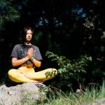 woman meditating in forest