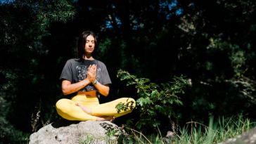 woman meditating in forest