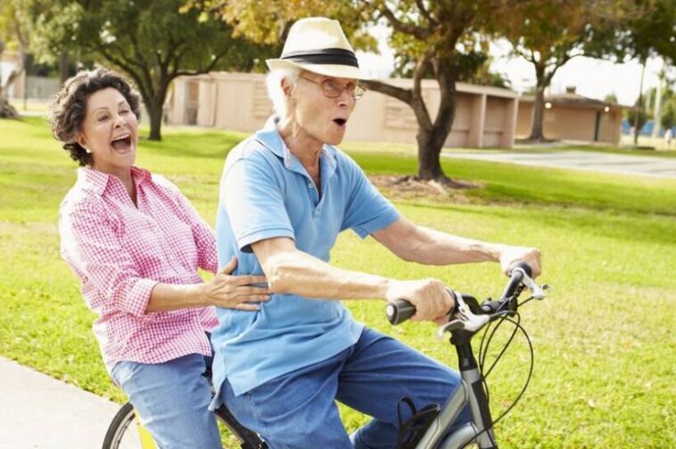 elderly couple on bike